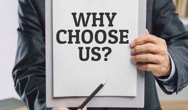business man holding clipboard with why choose us question